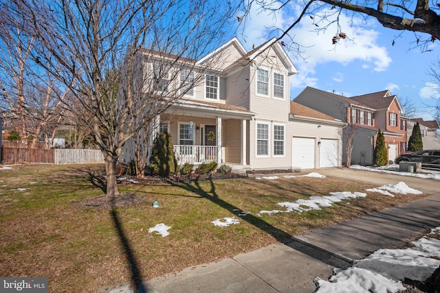 view of front property featuring covered porch, a front lawn, and a garage