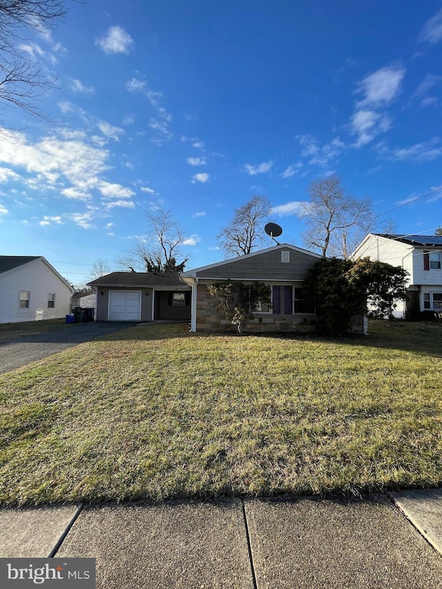 view of front of house with a garage and a front lawn