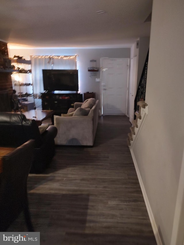 living room with dark hardwood / wood-style flooring