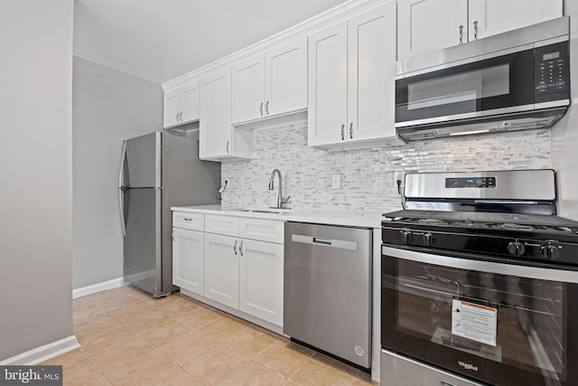 kitchen with white cabinets, light tile patterned floors, sink, and appliances with stainless steel finishes