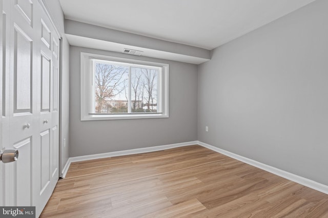 spare room featuring light hardwood / wood-style flooring