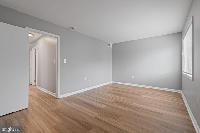 unfurnished room with light wood-type flooring