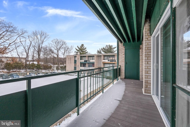 view of snow covered back of property