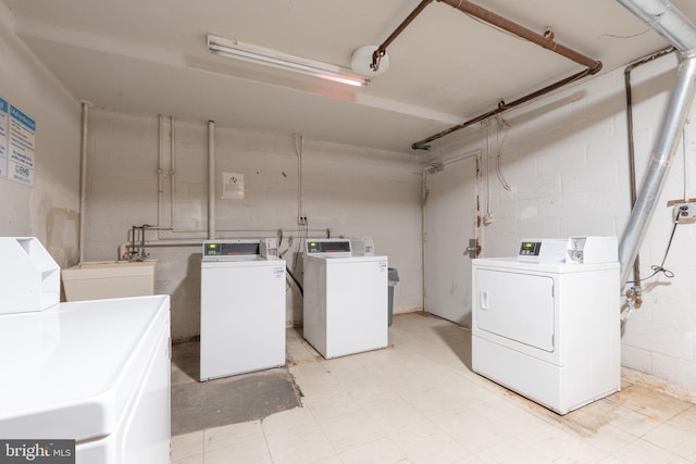 washroom with washer and clothes dryer and sink