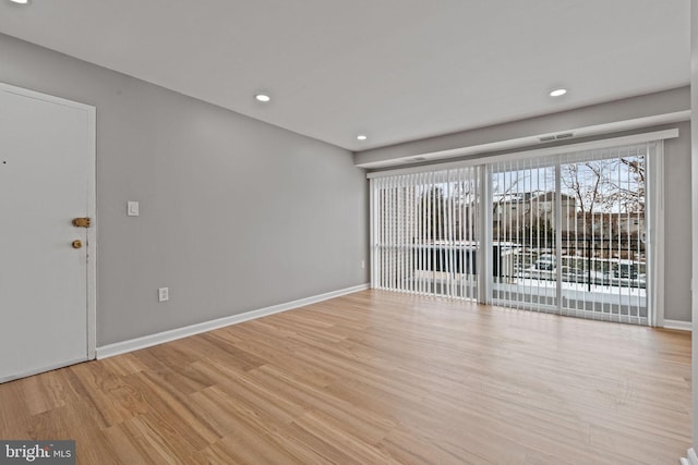 spare room featuring light hardwood / wood-style floors