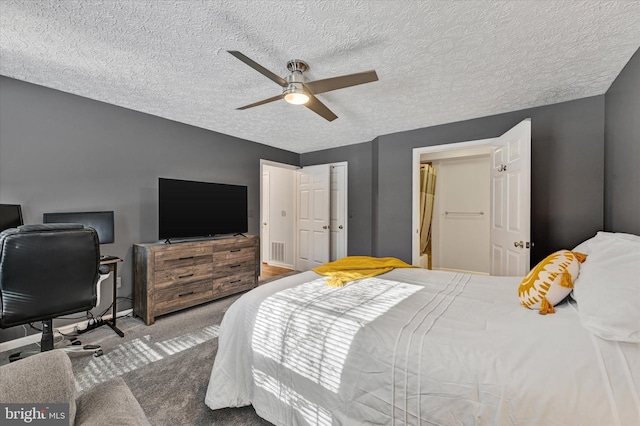 carpeted bedroom with a textured ceiling and ceiling fan