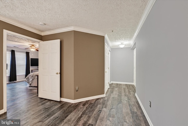 hall featuring a textured ceiling, hardwood / wood-style floors, and crown molding