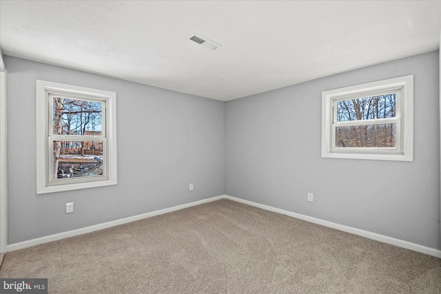 spare room featuring carpet flooring