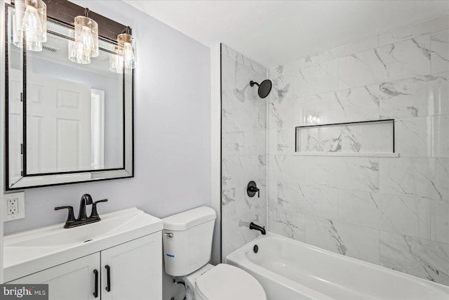 full bathroom featuring toilet, vanity, and tiled shower / bath