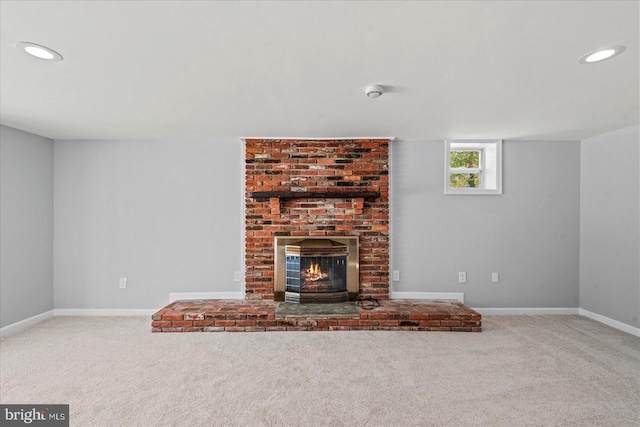 unfurnished living room featuring carpet flooring and a fireplace