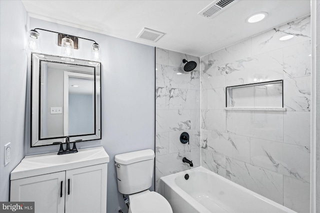 full bathroom with tiled shower / bath combo, toilet, and vanity