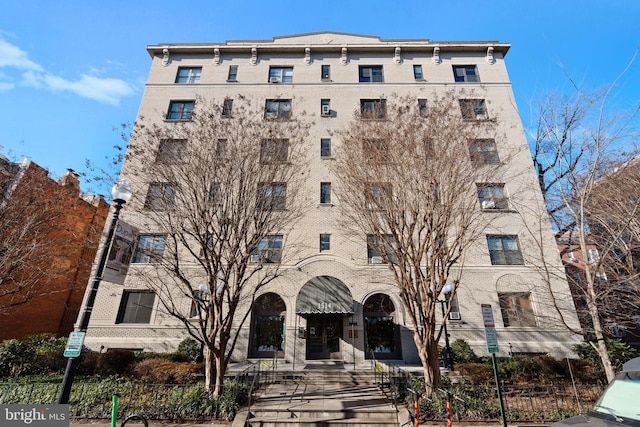 view of building exterior featuring a fenced front yard