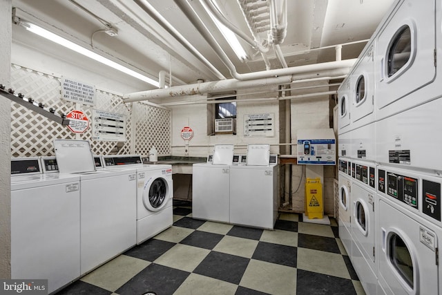 common laundry area with separate washer and dryer, stacked washer / drying machine, and light floors