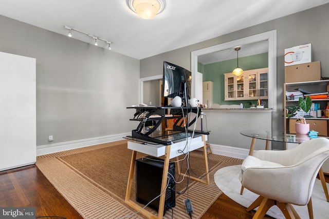 miscellaneous room featuring track lighting, baseboards, and wood finished floors