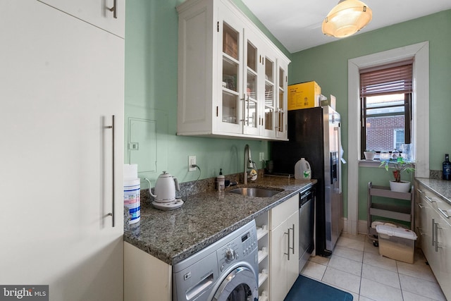 kitchen featuring high end white fridge, dishwasher, dark stone counters, washer / dryer, and a sink