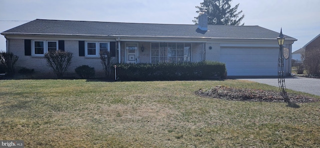 ranch-style home featuring driveway, a front lawn, a garage, brick siding, and a chimney