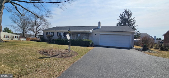 ranch-style house featuring aphalt driveway, a garage, a chimney, and a front lawn