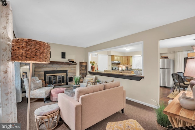 living room with a stone fireplace