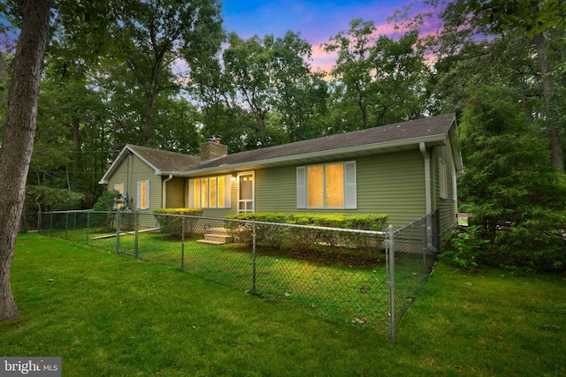 ranch-style home featuring a yard