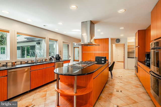 kitchen featuring sink, a breakfast bar area, a kitchen island, island exhaust hood, and stainless steel appliances