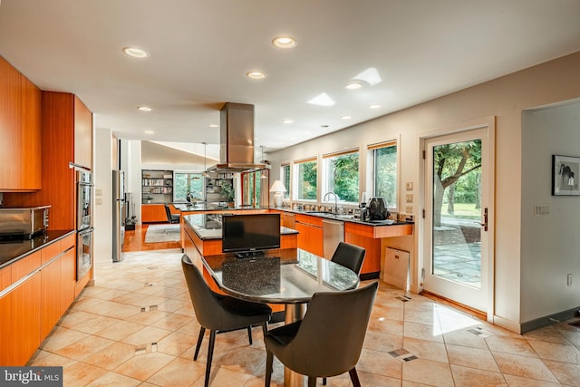 dining space with light tile patterned floors and sink