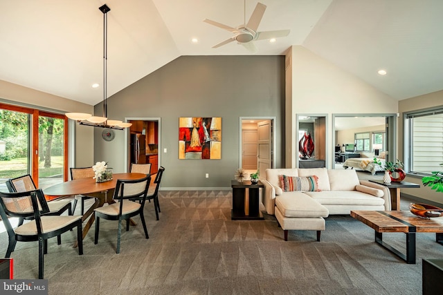 living room with ceiling fan, high vaulted ceiling, and dark colored carpet