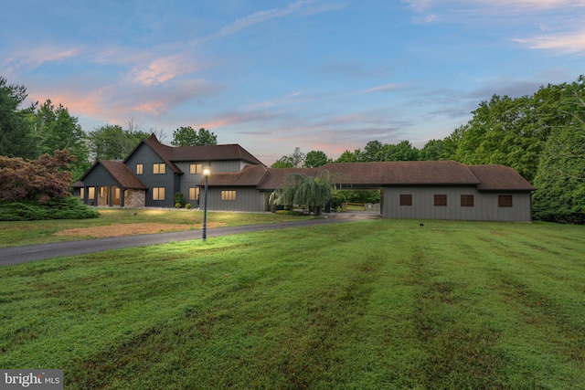 view of front facade featuring a carport and a lawn