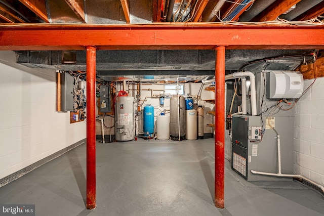 basement featuring gas water heater and electric panel