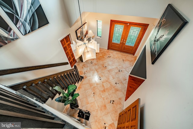 foyer with french doors and a towering ceiling