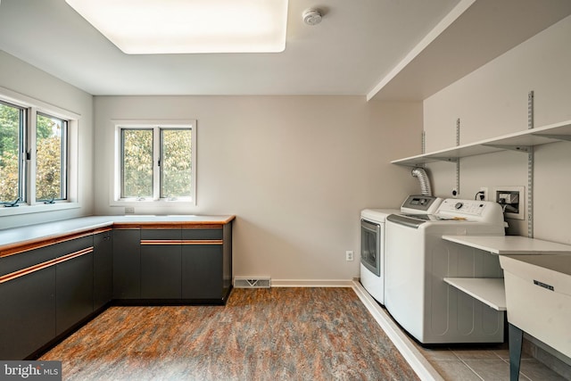 washroom with washing machine and dryer and sink