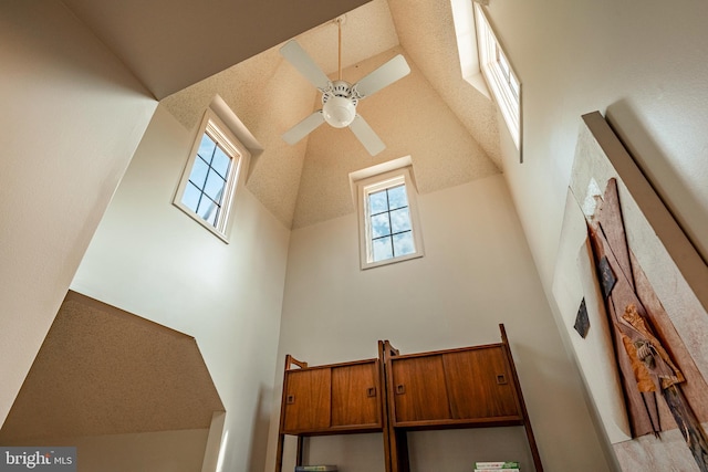 interior space with ceiling fan