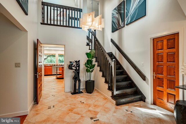 staircase featuring a towering ceiling