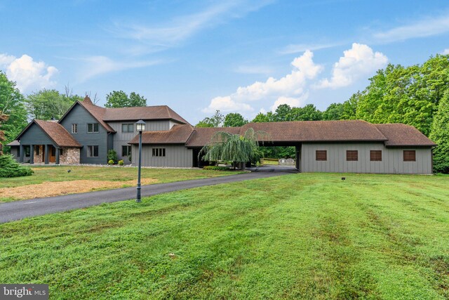 view of front facade with a carport and a front lawn