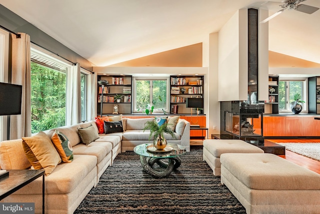 living room featuring hardwood / wood-style floors, ceiling fan, and lofted ceiling