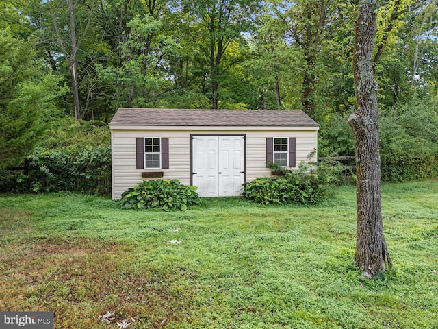 view of outbuilding featuring a lawn