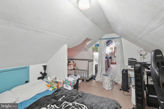 bedroom featuring a textured ceiling and vaulted ceiling