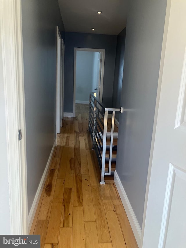 hallway with light hardwood / wood-style floors