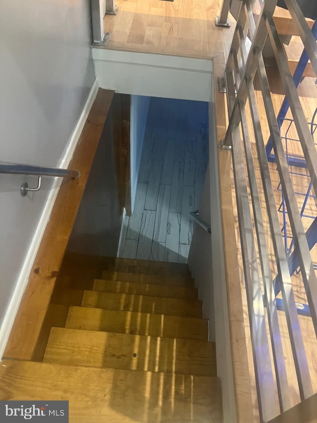 staircase with hardwood / wood-style floors