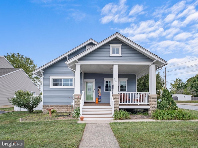 view of front facade with a front lawn and a porch