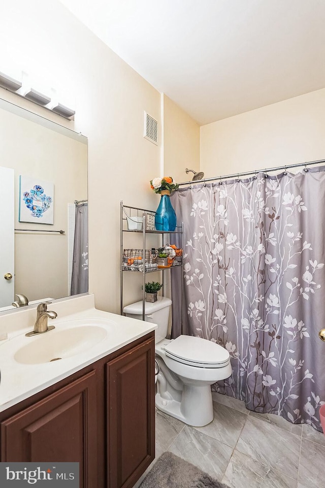 bathroom with vanity and toilet