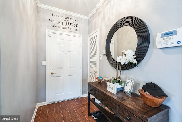 foyer with ornamental molding and dark hardwood / wood-style floors