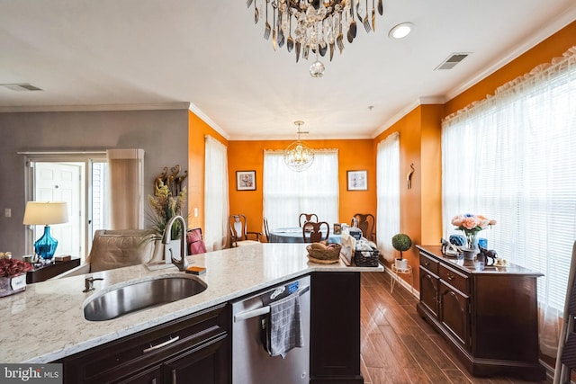 kitchen with pendant lighting, dishwasher, sink, a chandelier, and a center island