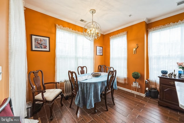 dining room with an inviting chandelier, crown molding, and a wealth of natural light