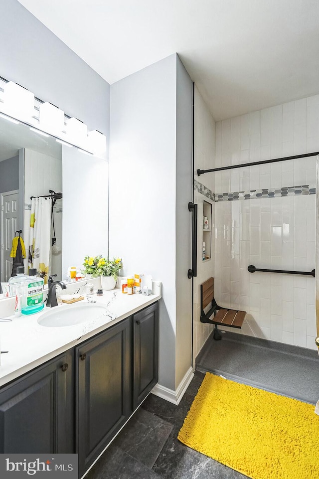 bathroom with vanity and a tile shower