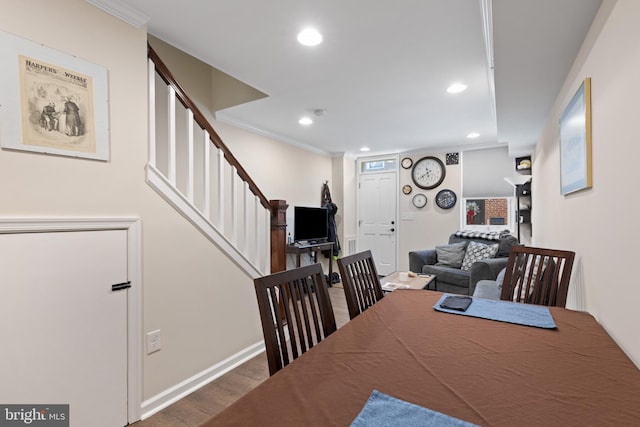 dining area with dark hardwood / wood-style floors and ornamental molding