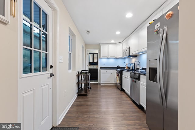 kitchen featuring dark hardwood / wood-style floors, sink, white cabinetry, and stainless steel appliances