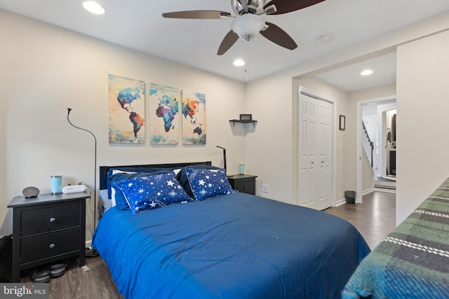 bedroom with dark hardwood / wood-style floors, a closet, and ceiling fan