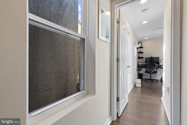 corridor with hardwood / wood-style flooring