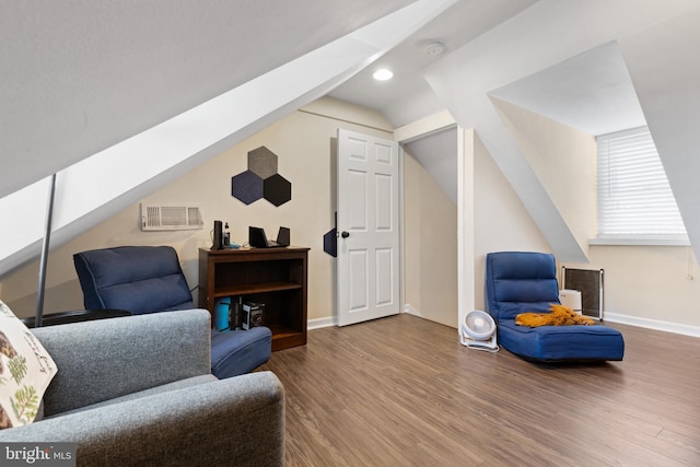 sitting room with wood-type flooring and vaulted ceiling