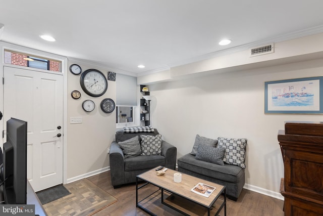 living room featuring dark hardwood / wood-style flooring and ornamental molding